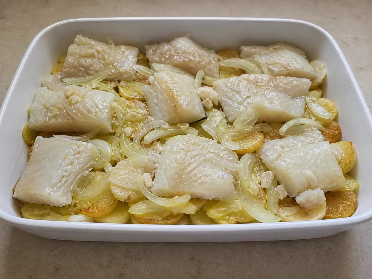 Preparação de Bacalhau Gratinado com Natas e Queijo durante a confeção