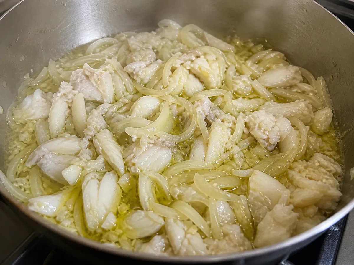 Preparação de Bacalhau à Gomes de Sá durante a confeção