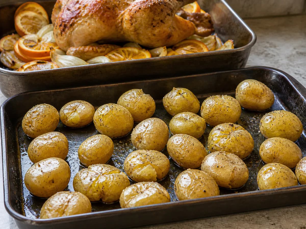 Preparação de Frango do Campo Assado em Molho de Mostarda e Laranja com Abacaxi e Batata a Murro durante a confeção