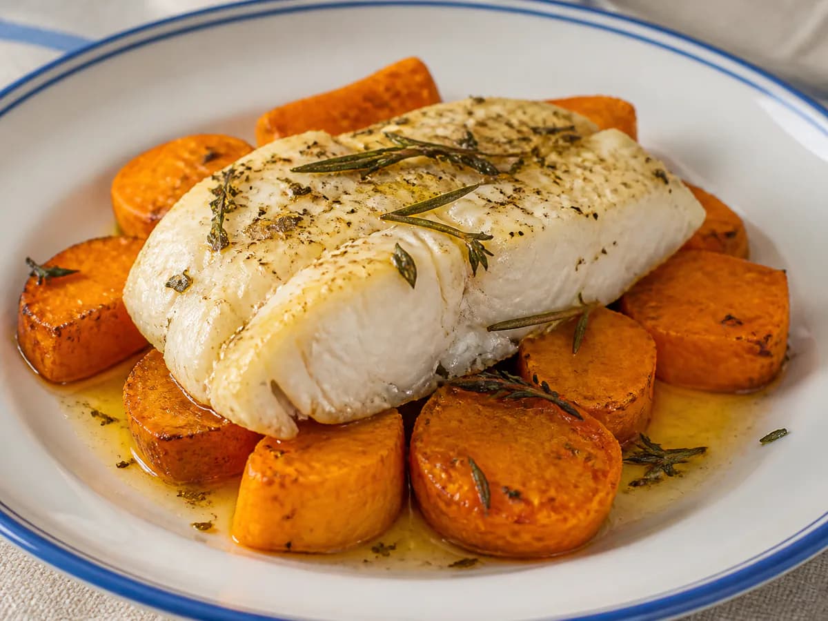 Pormenor de uma porção de Peixe no Forno com Batata Doce e Ervas Aromáticas
